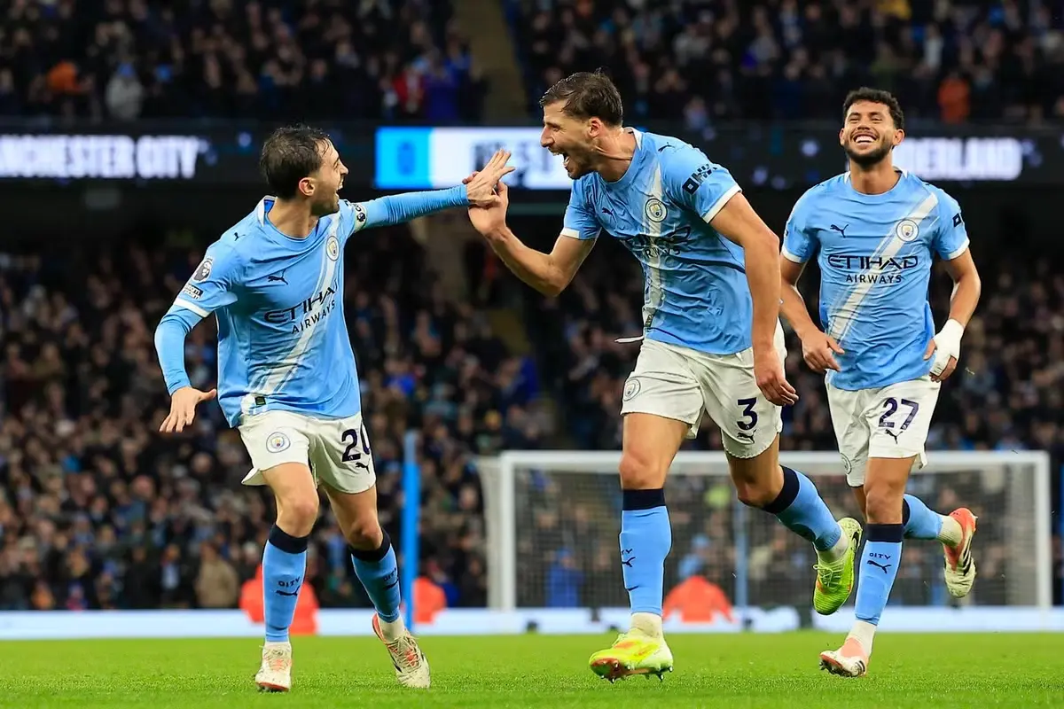 uben Dias celebrates with his Manchester City teammates